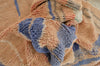 a close up of a teddy bear with a blue shirt 